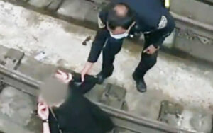 Watch: new york city cop jumps onto subway tracks to rescue woman who fell during medical episode