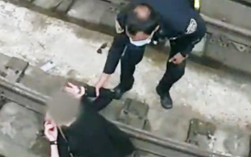 Watch: New York City Cop Jumps onto Subway Tracks to Rescue Woman Who Fell During Medical Episode