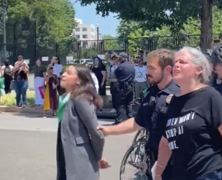 Aoc pretends to be handcuffed during arrest at supreme court protest - photo licensed by shore news network.