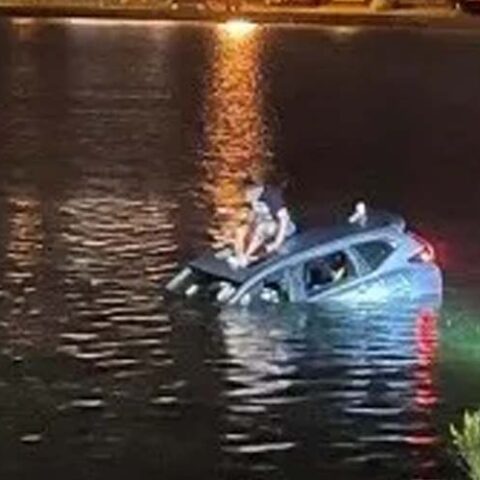 Man drives car into lake after blowing through stop sign at the jersey shore - photo licensed by shore news network.