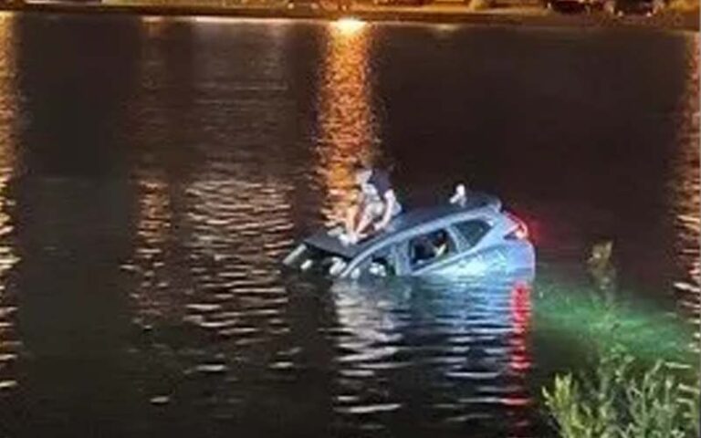 Man drives car into lake after blowing through stop sign at the jersey shore - photo licensed by shore news network.