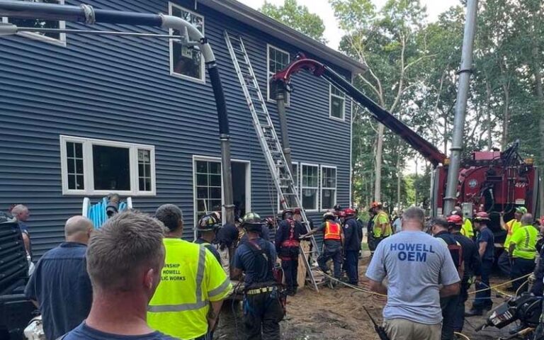Worker rescued after being trapped in collapsed hole, 10 feet deep in howell - photo licensed by shore news network.