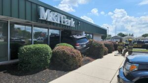 Car drives into bank lobby in dover, pinning employee