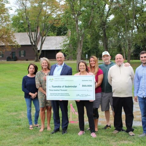 Commissioner deputy director melonie marano presented bedminster mayor lawrence jacobs with a check for $300,000 from the county’s recreational open space fund to build a community garden at river road park alongside the historic jacobus vanderveer house.