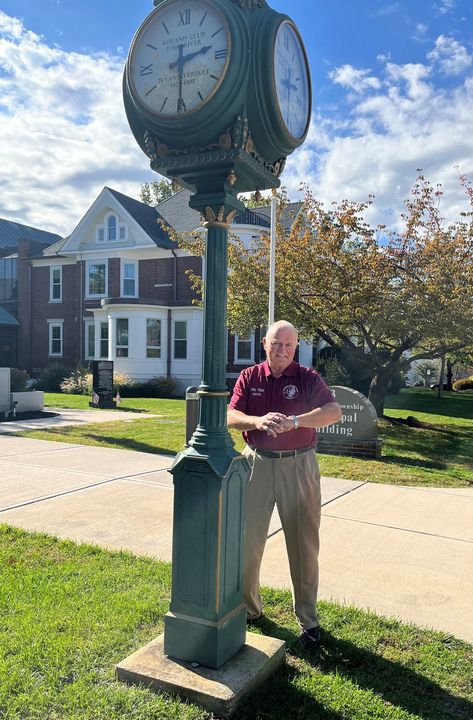 Mayor Mo Hill is checking the time on the newly repaired clock at Town Hall.