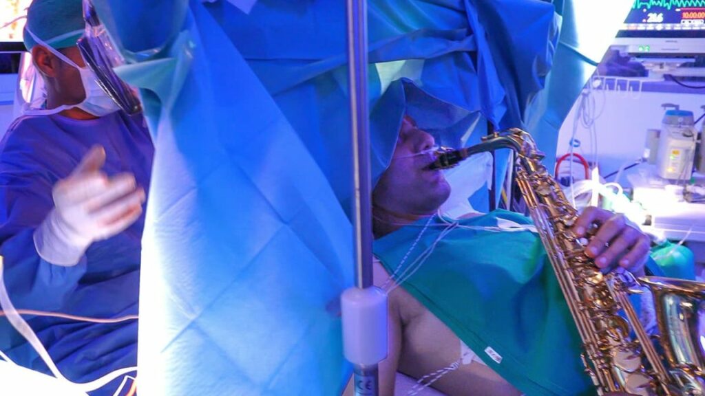 Man plays saxophone while undergoing brain surgery. Photo by Paideia Hospital