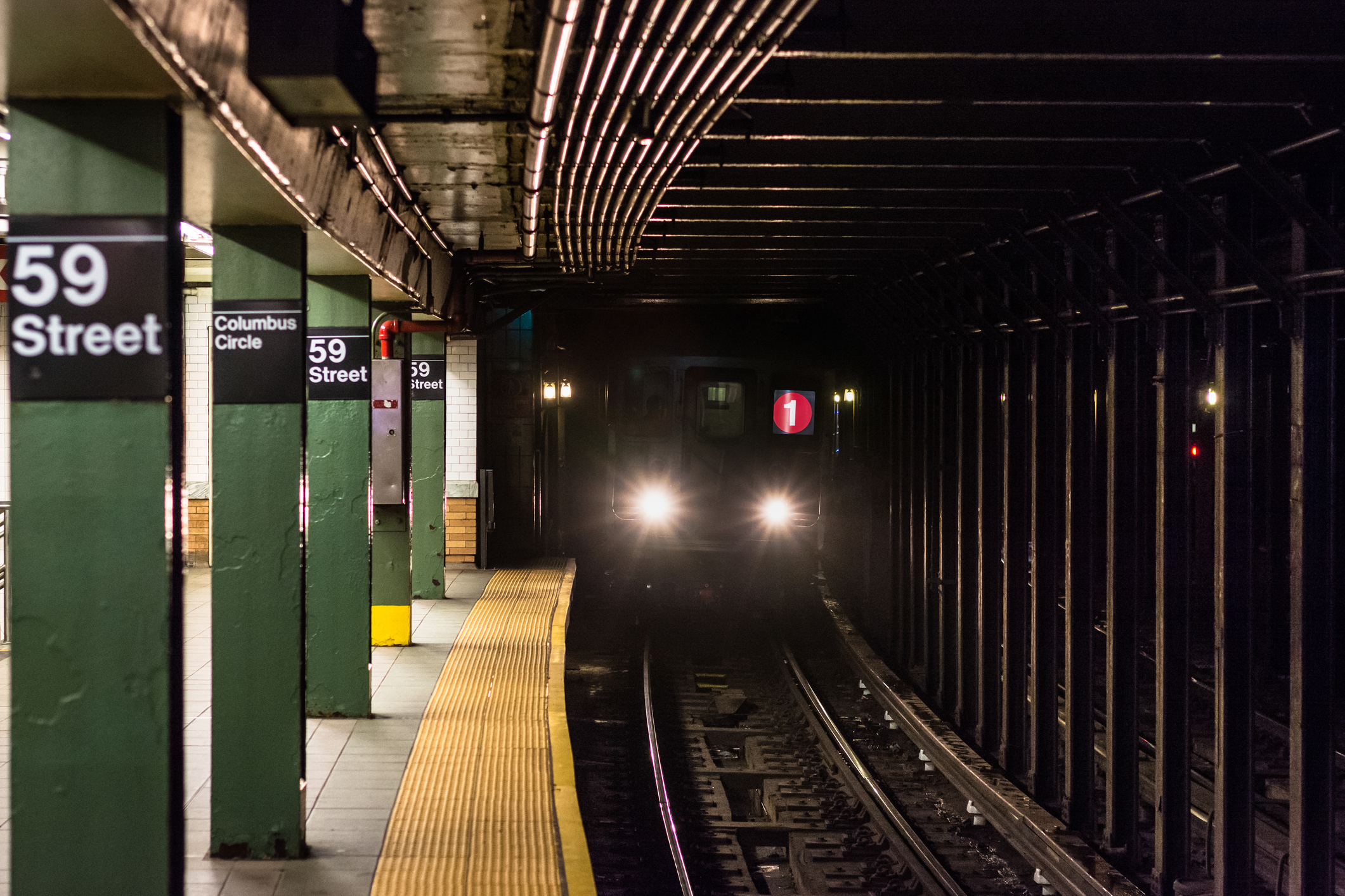 A train approaching the platform at Columbus Circle subway station in Manhattan, New York City - Photo by Jon Bilous,