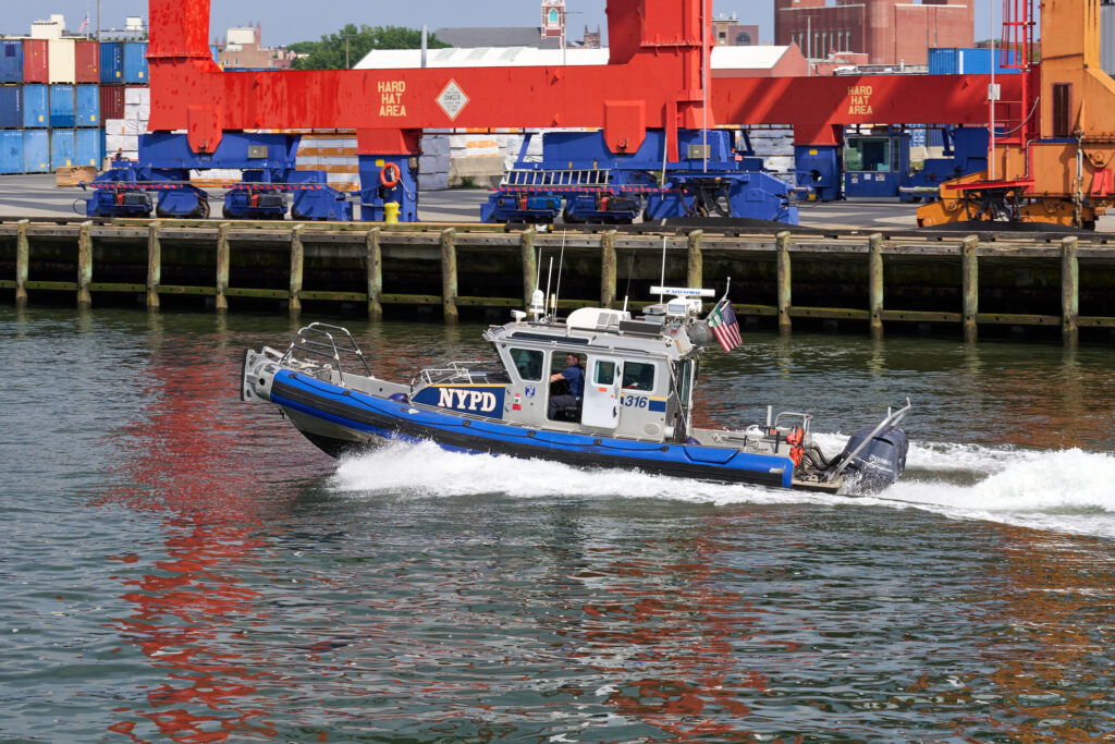 A NYC Police Dept. inflatable boat patrols New York Harbor. Photo 251231948 © John Penne