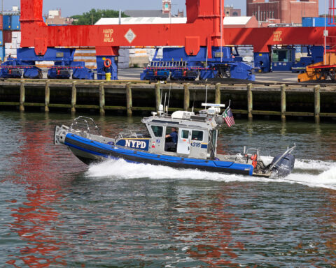 A NYC Police Dept. inflatable boat patrols New York Harbor. Photo 251231948 © John Penne