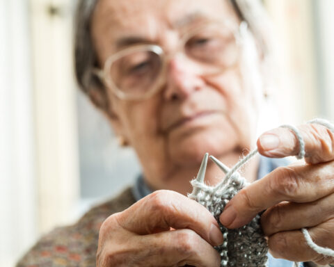 Close up of the hands of an elderly woman knitting, could possibly be a deadly weapon under NJ law.
