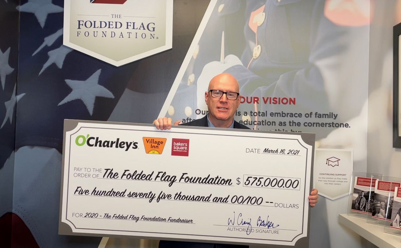 O'Charley's Raises $575,000 for the Folded Flag Foundation to Support the Spouses and Children of Fallen Heroes O'Charley's CEO Craig Barber presenting The Folded Flag Foundation with a check for $575,000.
