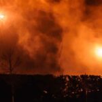 Fire seen beyond the tree line. File Photo