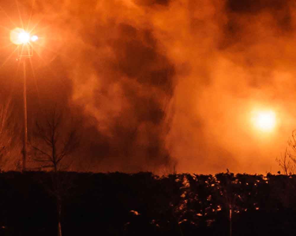 Fire seen beyond the tree line. File Photo
