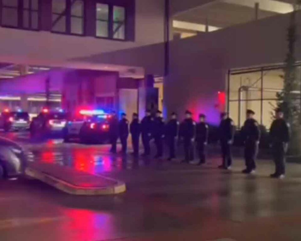 Officers line up at the hospital as the body of Bayonne Police Department Captain Paul Jamolawicz. Captain Jamolawicz is transported.
