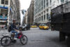 New York City, USA - July 25, 2018: Seventh Avenue and 34th Street with a cyclist with an electric bike and people around in Manhattan in New York City,