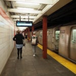 NYC subway train inside station.