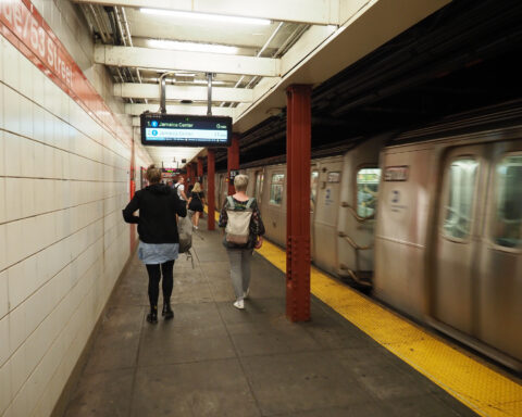 NYC subway train inside station.