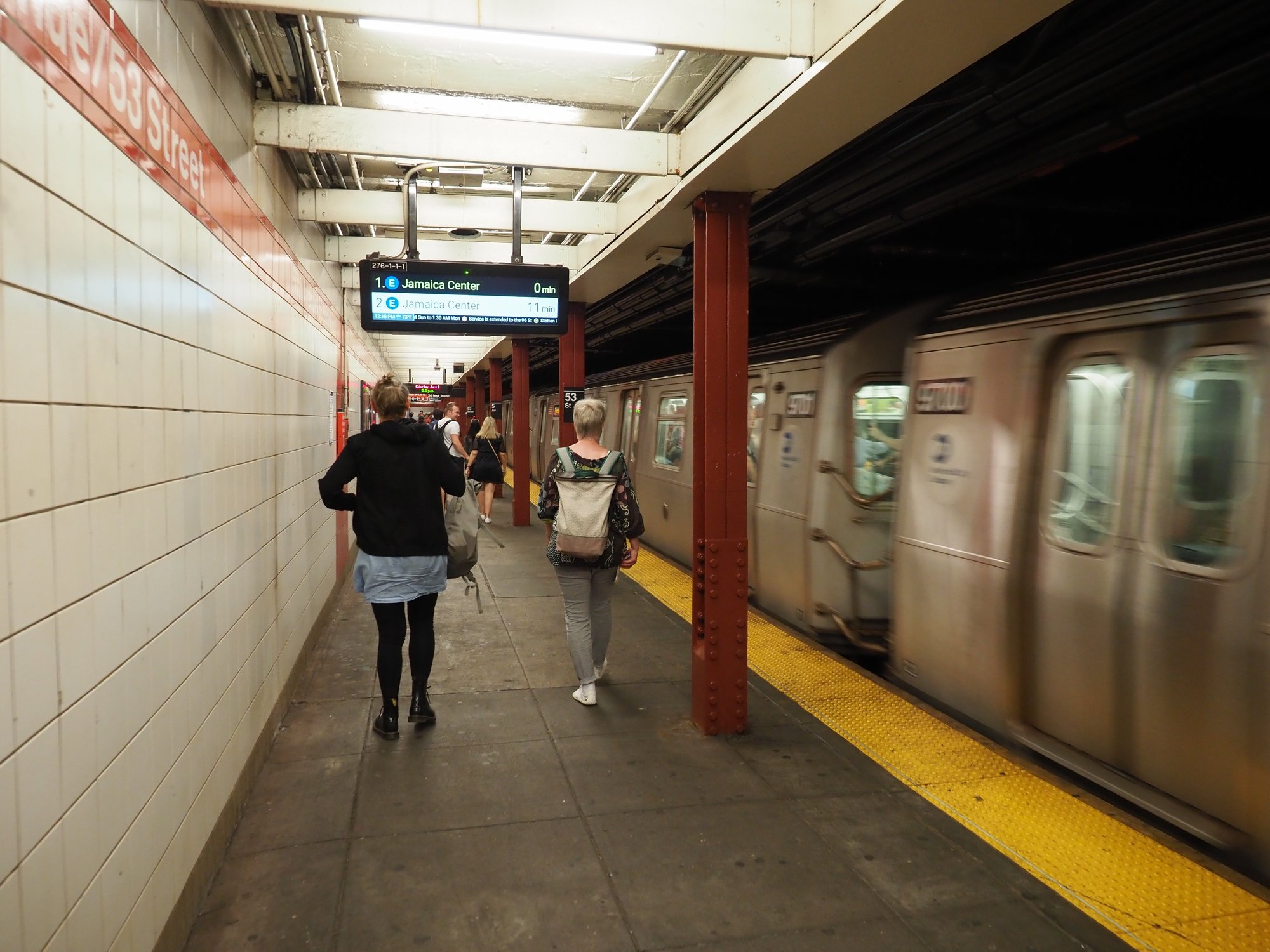 NYC subway train inside station.
