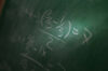 Math problem writing on a chalk board