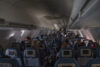 : flight attendants doing the drink and snack service on the domestic flight. Flight service,airplane cabin,airplane,drink,