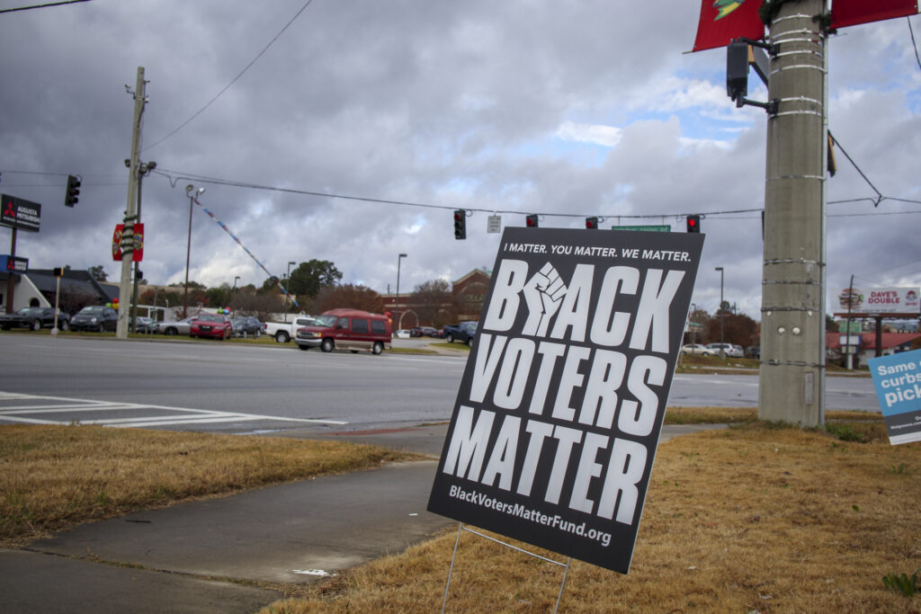 Augusta, Ga USA - 12 14 20: It`s about us street sign, on the reverse is Black voters matter