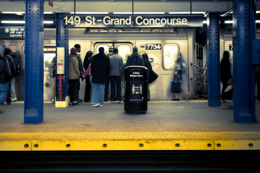 Bronx, New York City, USA - Commuters on Grand Concourse subway platform in the Bronx, New York City. There are 468 subway stations in the NYC transit system.