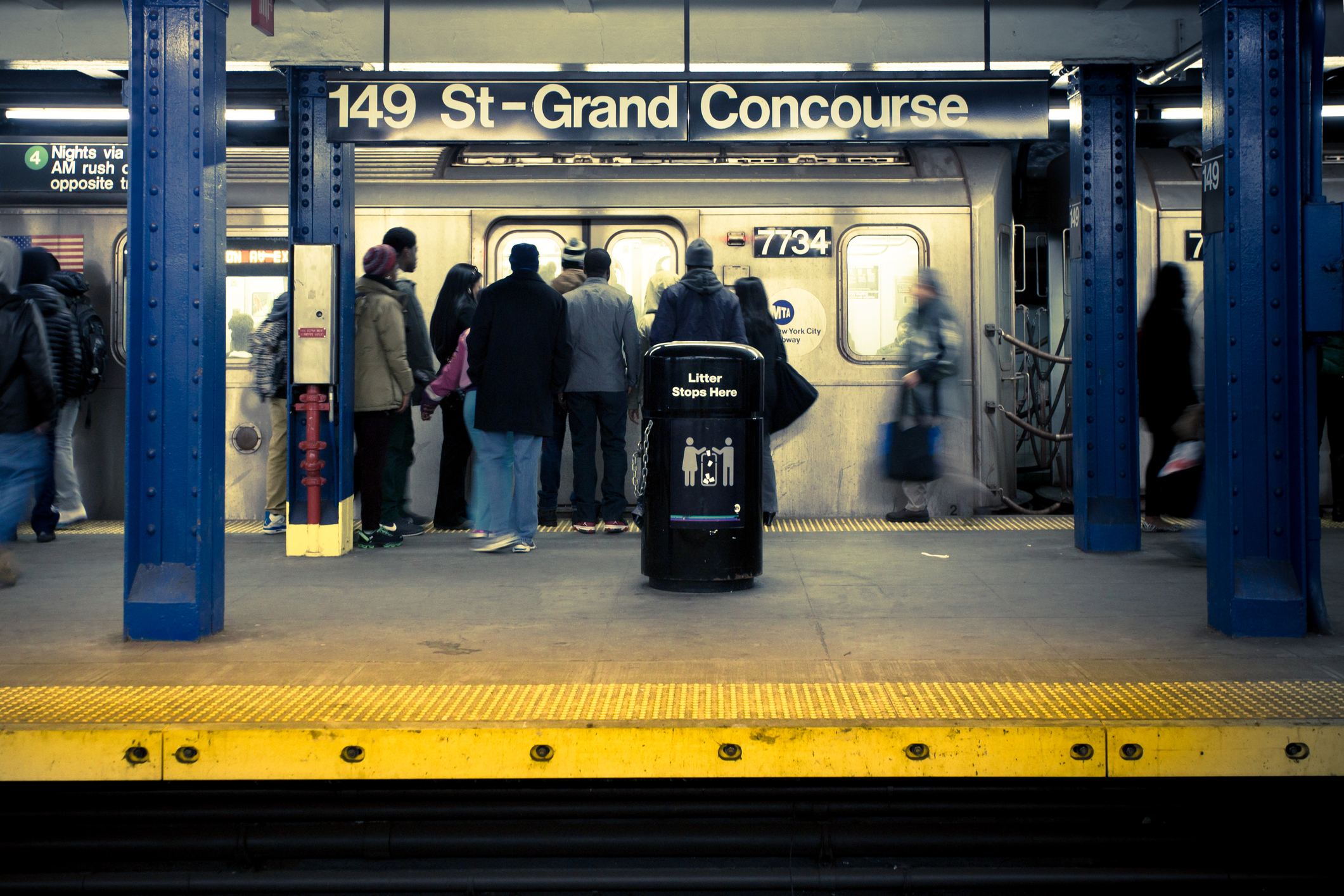 Bronx, New York City, USA - Commuters on Grand Concourse subway platform in the Bronx, New York City. There are 468 subway stations in the NYC transit system.