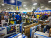 People shopping in a best buy store during black frida