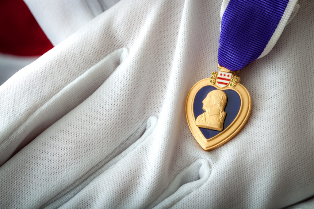 Photo by Victor Moussa - Purple heart presented with white gloves