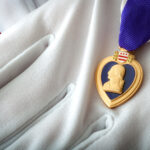 Photo by Victor Moussa - Purple heart presented with white gloves