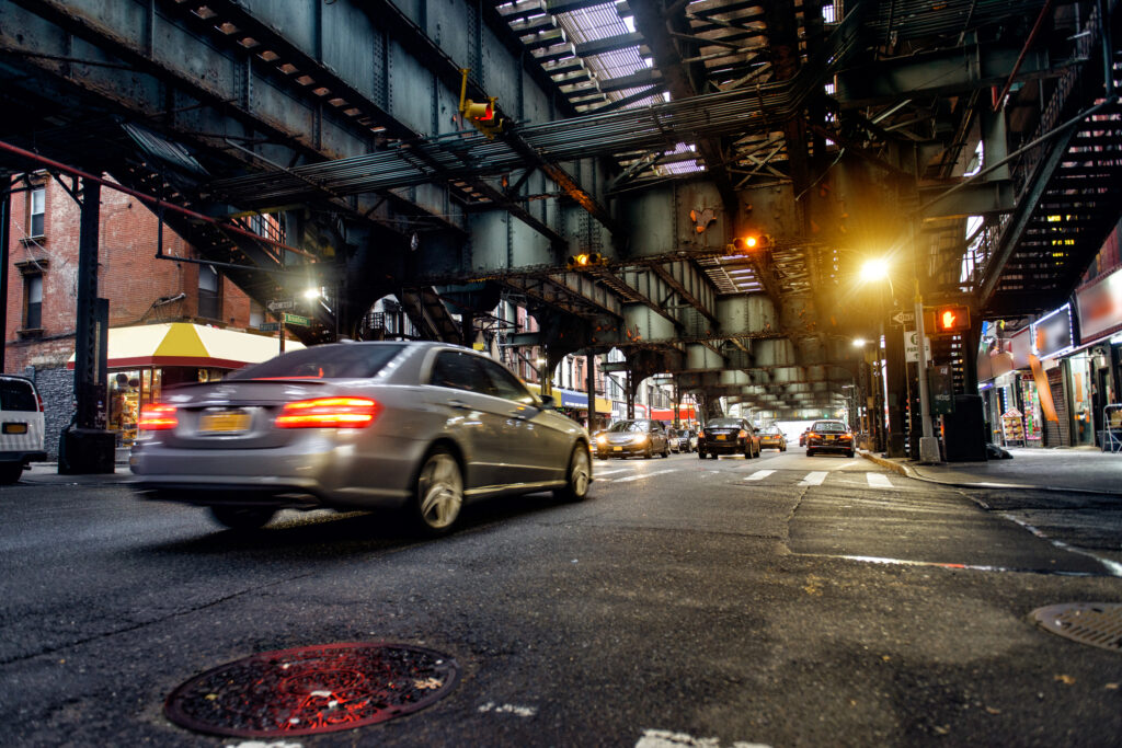 NYC subway tracks above street in Brooklyn.