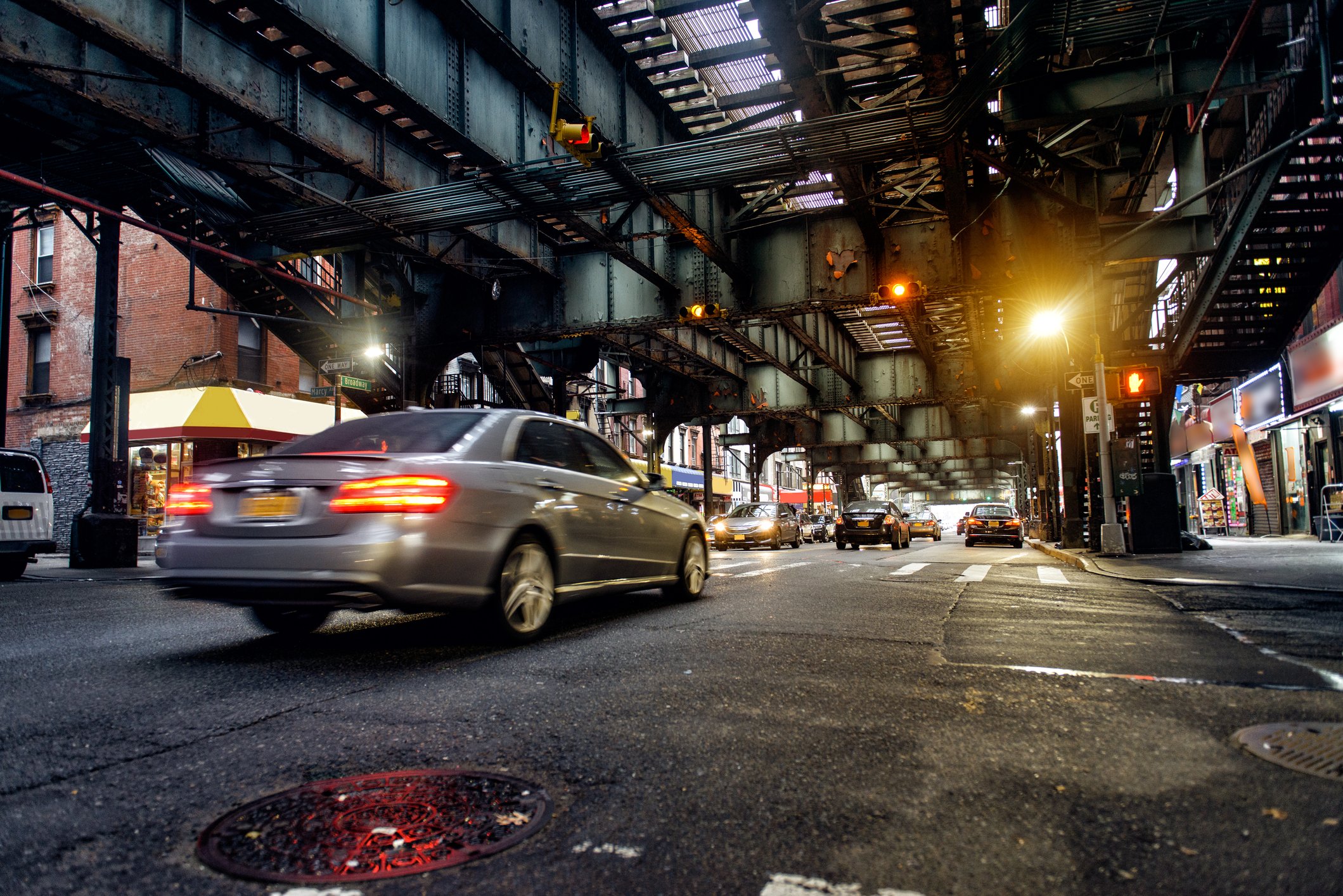 NYC subway tracks above street in Brooklyn.