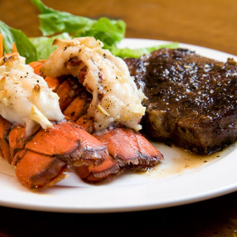 Juicy grade aaa angus new york strip sirloin steak with lobster tails