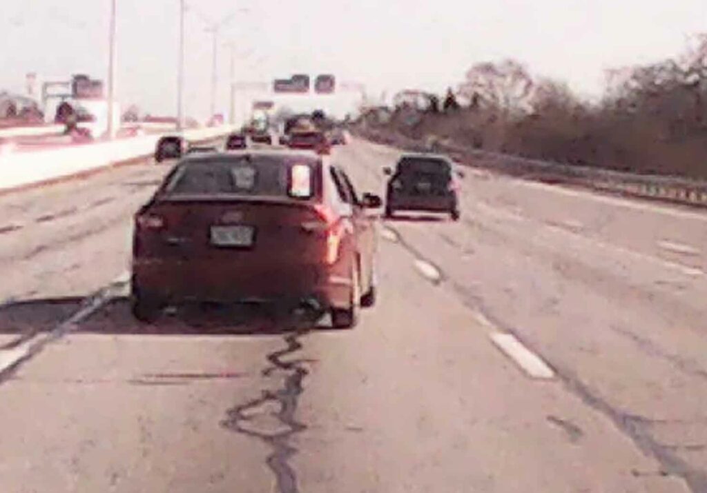 Detectives have released dash camera video of a red four-door sedan that was involved in a shooting on I-70 near downtown Columbus on December 9, 2022.