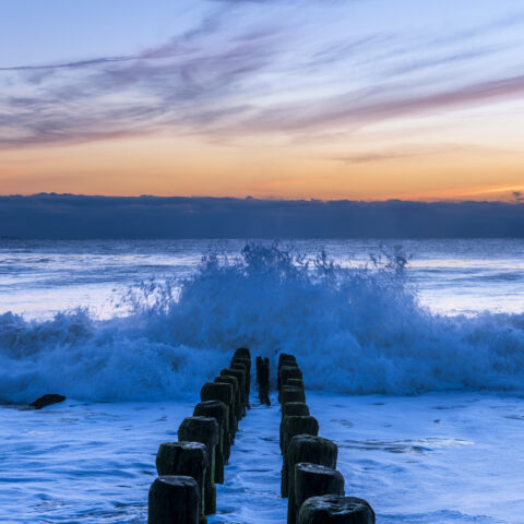 Beautiful ocean waves during sunrise under colorful sky at bay head, new jersey