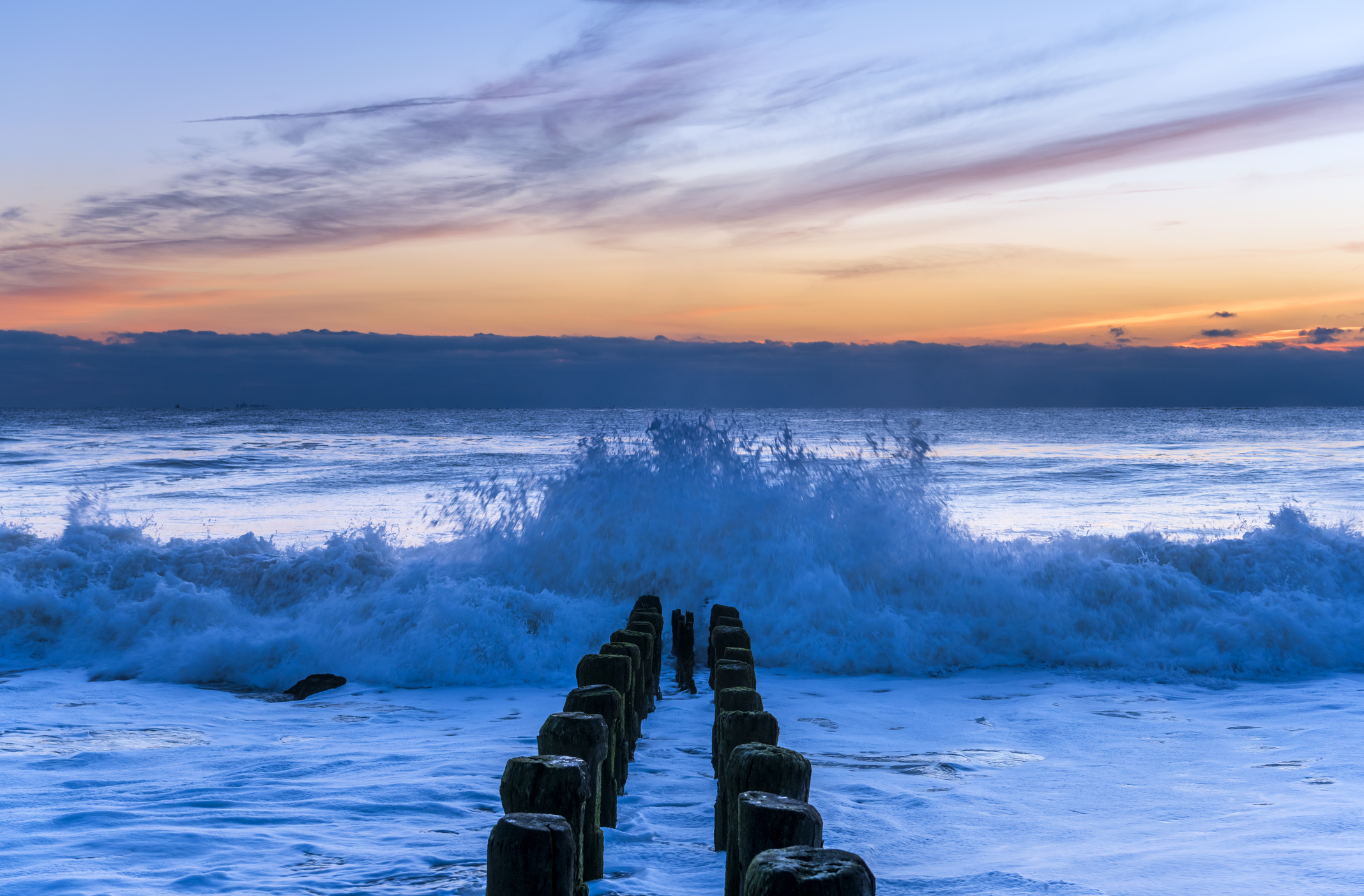 Beautiful ocean waves during sunrise under colorful sky at Bay Head, New Jersey