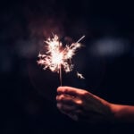 Hand holding sparkler - File Photo
