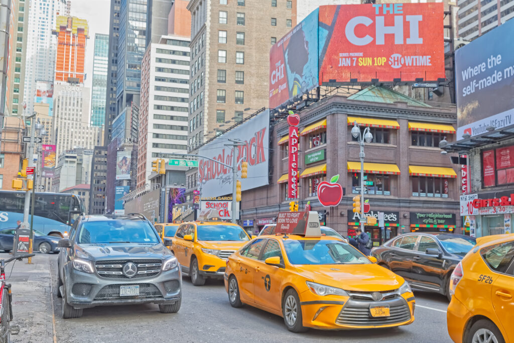 Traffic at Broadway and 50th street on sunny winter day, Manhattan New York City USA.
