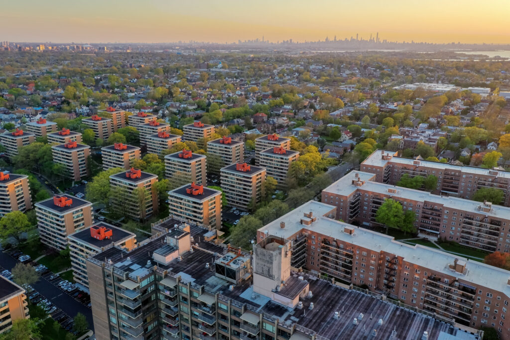 Aerial view of Queens in New York City at sunset with the George Washington Bridge in the background