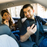 Male rideshare driver picks up female customer.