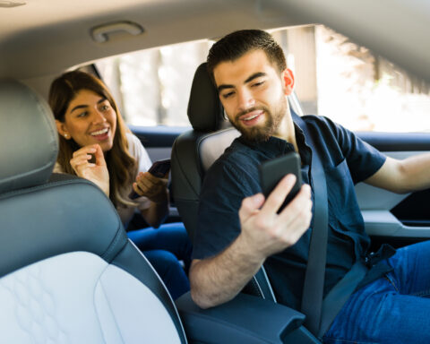 Male rideshare driver picks up female customer.