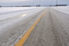 Close up of slippery icy slushy pavement road in winter