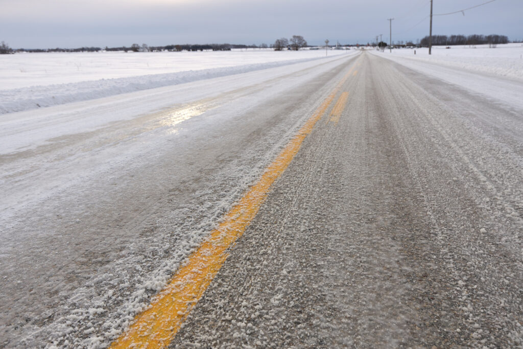 Close up of Slippery Icy Slushy Pavement Road in Winter