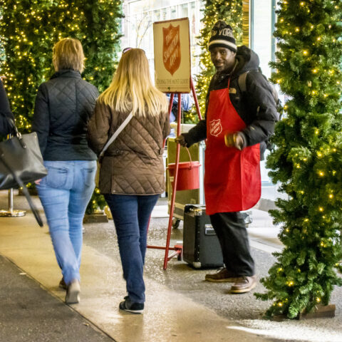 Volunteers with the traditional red kettle and bell are a common sight in new jersey during the christmas season.