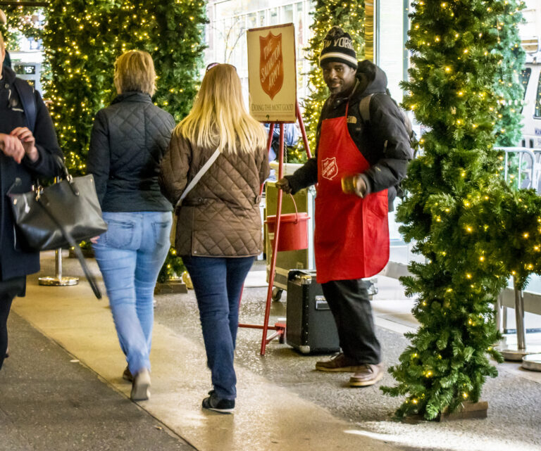 Volunteers with the traditional red kettle and bell are a common sight in new jersey during the christmas season.