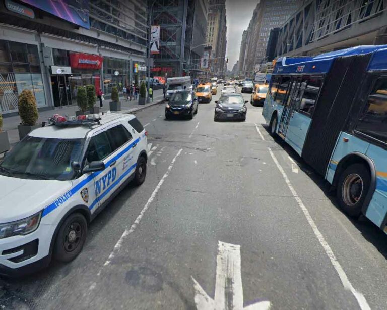 Nypd cruiser and port authority bus outside manhattan's port authority bus terminal