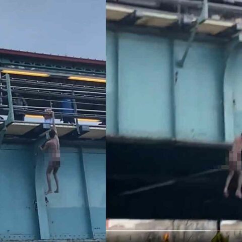 Naked man hanging from elevated train tracks in the bronx caught on video - photo licensed by shore news network.