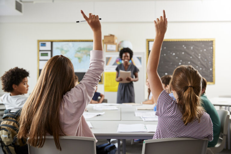 Students in school classroom, teacher.