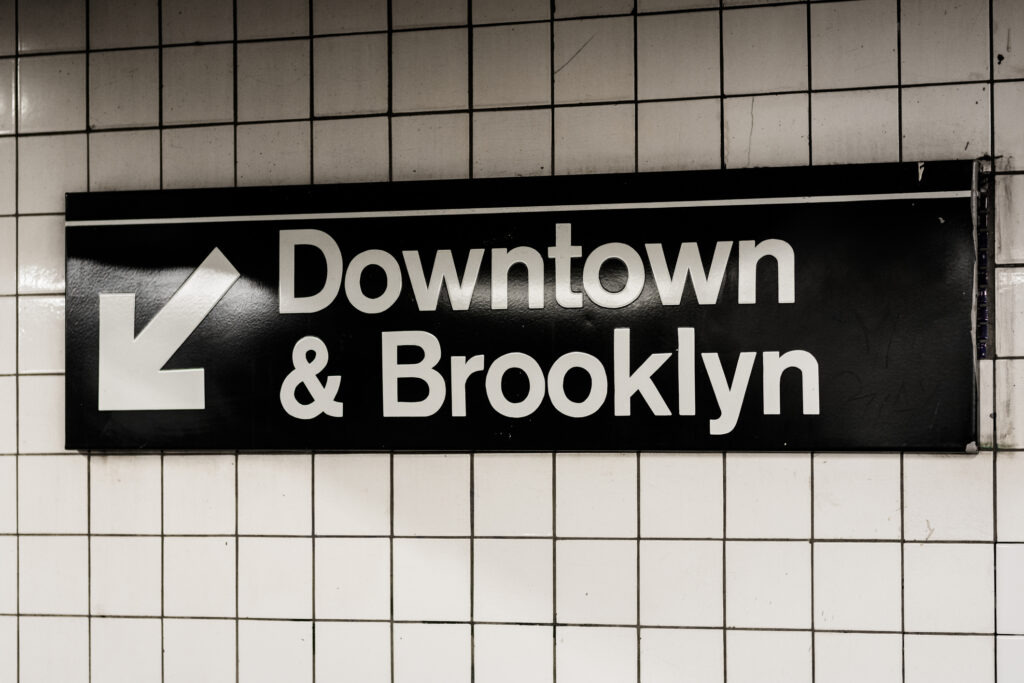 Downtown & Brooklyn sign in a subway station in Manhattan, New York City