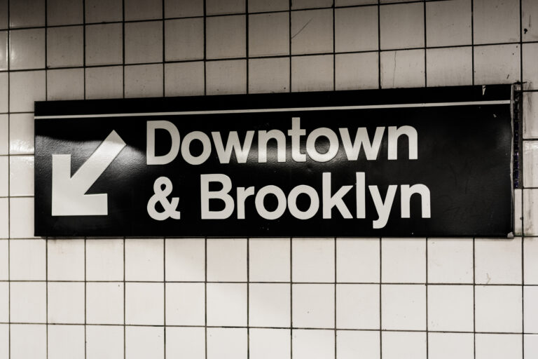 Downtown & Brooklyn sign in a subway station in Manhattan, New York City